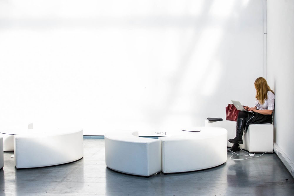 woman charging her laptop at a conference