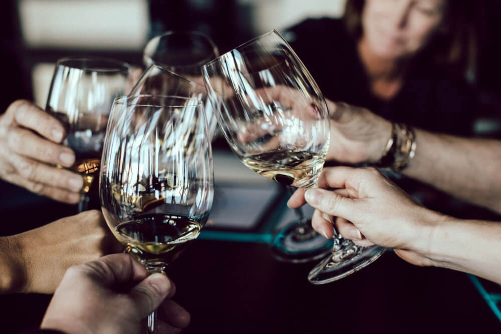 happy hour cheers with wine glasses